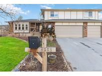 Brick home with two-car attached garage and landscaped yard at 5385 Camargo Rd, Littleton, CO 80123