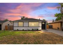 Charming single-story home with a well-maintained lawn and a lovely sunset backdrop at 742 Hanover St, Aurora, CO 80010
