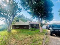 Charming two-story home with brick accents, mature trees, and a welcoming front porch at 2281 Fairplay St, Aurora, CO 80011