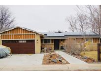 Charming single-story home featuring solar panels, a two-car garage, and low-maintenance landscaping at 310 S Marshall St, Lakewood, CO 80226
