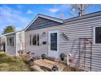 Charming home featuring light gray siding, new roof details, and front yard landscaping at 5301 E Eastman Ave, Denver, CO 80222