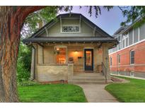 Charming brick home with a welcoming porch and a well-manicured lawn at 1172 Harrison St, Denver, CO 80206