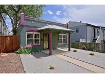 Charming single-story home featuring an inviting porch, decorative stars, and low-maintenance gravel landscaping at 2424 N Clay St, Denver, CO 80211