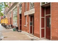 Charming red brick building showcasing architectural detail and inviting entrances at 3211 Zuni St # 14, Denver, CO 80211
