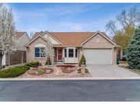 Charming brick home featuring a well-manicured front yard and two-car garage at 1185 S Kramer Ct, Aurora, CO 80012