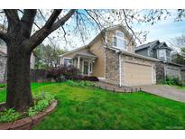 Charming two-story home features a stone and vinyl facade, well-manicured lawn, and an attached two-car garage at 3565 W 112Th Cir, Westminster, CO 80031