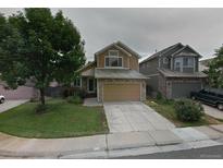 Inviting two-story home with stone accents, a well-manicured lawn, and a spacious two-car garage at 3565 W 112Th Cir, Westminster, CO 80031