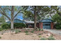 Charming single-story home with brick accents, mature trees, landscaping and attached garage at 120 Field St, Lakewood, CO 80226