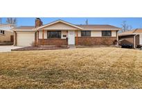 Charming single-story home boasting brick accents and a well-maintained front yard at 1667 S Balsam Ct, Lakewood, CO 80232