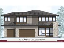Modern two-story home with stone accents, gray siding, and a three-car garage in Louisville, CO at 945 Saint Andrews Ln, Louisville, CO 80027