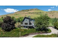 Contemporary two-story home with gray exterior and a hillside view at 14150 Foothill Ln, Golden, CO 80401