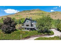 Stunning two-story home with modern architecture and lush landscaping on a hillside setting at 14150 Foothill Ln, Golden, CO 80401
