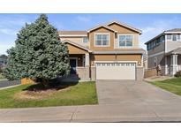 Charming two-story home with a well-maintained lawn and a two-car garage at 2736 Poplar Grove Pl, Castle Rock, CO 80109