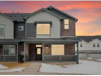 Charming two-story home with beautiful brick and siding exterior, with a cozy front porch at 6571 N Malaya St, Aurora, CO 80019
