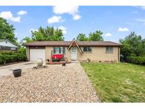 Charming brick home with a well-maintained front yard and inviting porch swing at 12167 E Exposition Ave, Aurora, CO 80012