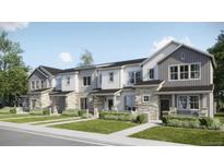 Charming townhomes featuring stone accents, manicured lawns, and inviting entrances for a welcoming curb appeal at 6688 E 149Th Ave # 1, Thornton, CO 80602