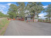 Charming home featuring mature trees, private drive and deck with mountain views at 25601 Centennial Trl, Golden, CO 80401