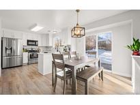 Bright kitchen with stainless steel appliances and white cabinets at 9573 Castle Ridge Cir, Highlands Ranch, CO 80129