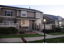 Charming townhome featuring stone accents, covered entry, and well-maintained landscaping at 4746 Raven Run, Broomfield, CO 80023
