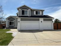 Beautiful two-story home featuring a three-car garage and painted brick accents at 2050 Lake Circle Dr, Thornton, CO 80241