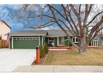 Charming green ranch-style home featuring an attached garage and a well-maintained front yard at 13298 Alcott Cir, Broomfield, CO 80020