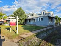 Charming single Gathering home with a well-maintained lawn and a real estate sign visible in the front yard at 2332 W Baltic Pl, Englewood, CO 80110