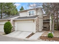 Charming home featuring stone accents, a two-car garage, manicured lawn, and inviting curb appeal at 4605 S Yosemite St # 36, Denver, CO 80237