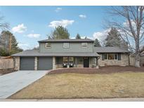 Charming two-story home with a three-car garage and inviting stone accents at 2616 S Leyden St, Denver, CO 80222