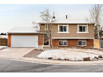 Charming two-story home with brick accents, attached garage, and a well-maintained front yard at 9240 W Wagon Trail Dr, Littleton, CO 80123