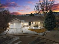 Attractive home exterior at dusk, featuring a two-car garage and landscaping at 2517 S Eldridge Ct, Lakewood, CO 80228