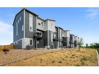 View of newly constructed townhomes with modern architecture and exterior balconies under a blue sky at 2740 W 68Th Ave, Denver, CO 80221