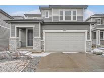 Charming two-story home featuring a two-car garage and stone accents at 4353 S Liverpool Ct, Aurora, CO 80015