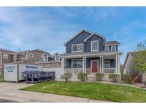 Charming two-story home featuring a welcoming front porch, stone accents, and a well-maintained lawn at 3367 Dove Valley Pl, Castle Rock, CO 80108