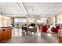 Bright living room featuring concrete ceiling, floor to ceiling windows, city views and modern decor at 1610 Little Raven St # 502, Denver, CO 80202