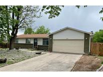 Ranch home with brick accents, neutral siding, well kept lawn, and an attached two-car garage at 3190 S Joplin Ct, Aurora, CO 80013