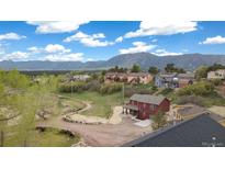 Charming multi-story home with picturesque mountain views and lush surrounding landscape at 826 Meadow Ln, Palmer Lake, CO 80133