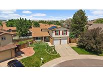 Charming two-story home with attached two-car garage, solar panels, manicured lawn and mature trees at 11149 Seton Pl, Westminster, CO 80031
