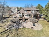 Expansive backyard with stone patio, deck, mature trees and landscaping offers great outdoor space at 6406 Eagle Ct, Longmont, CO 80503