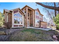 Stunning two-story home featuring a brick facade, expansive windows, and lush landscaping at 6406 Eagle Ct, Longmont, CO 80503