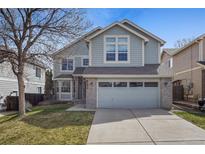 Charming two-story home featuring a two-car garage, well-maintained lawn, and beautiful exterior paint at 8414 Bed Straw St, Parker, CO 80134