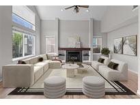 Bright living room with vaulted ceilings, a modern fireplace, large windows, and contemporary furnishings at 8414 Bed Straw St, Parker, CO 80134