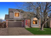 Charming two-story home with a two-car garage and a well-manicured front yard at 5027 E Barrington Ave, Castle Rock, CO 80104