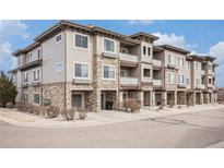 Inviting condo building with stone accents, balconies, and well-maintained landscaping at 9318 Las Ramblas Ct # R, Parker, CO 80134