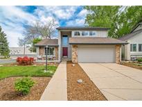 Charming two-story home featuring brick accents, a two-car garage, and a well-maintained front yard at 6398 S Emporia Cir, Englewood, CO 80111