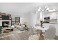 Bright, open-concept living and dining area with a fireplace and access to a balcony at 14720 E Kentucky Dr # 622, Aurora, CO 80012