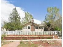 Charming single-story home featuring a well-maintained front yard and a classic white picket fence at 5040 Tennyson St, Denver, CO 80212