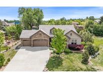 Beautiful home featuring stone accents, a three-car garage, and a well-maintained lawn at 3380 Quail Ct, Wheat Ridge, CO 80033