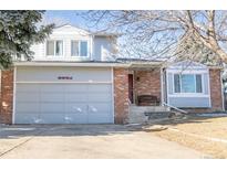 Brick and gray two-story house with a two-car garage and landscaping at 3321 S Dunkirk Way, Aurora, CO 80013