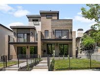 Modern, two-story home showcasing a unique facade with a mix of brick and wooden finishes and small front yard at 417 N Madison St, Denver, CO 80206