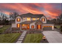 Charming two-story home featuring a manicured lawn and craftsman-style design elements at 15 Latigo Pl, Littleton, CO 80123